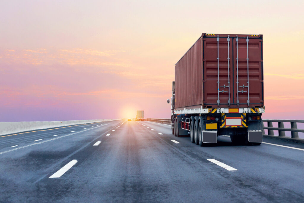 Cargo truck driving on a highway during sunset, symbolizing how fast information travels when looking up medical facts like is blood blue.