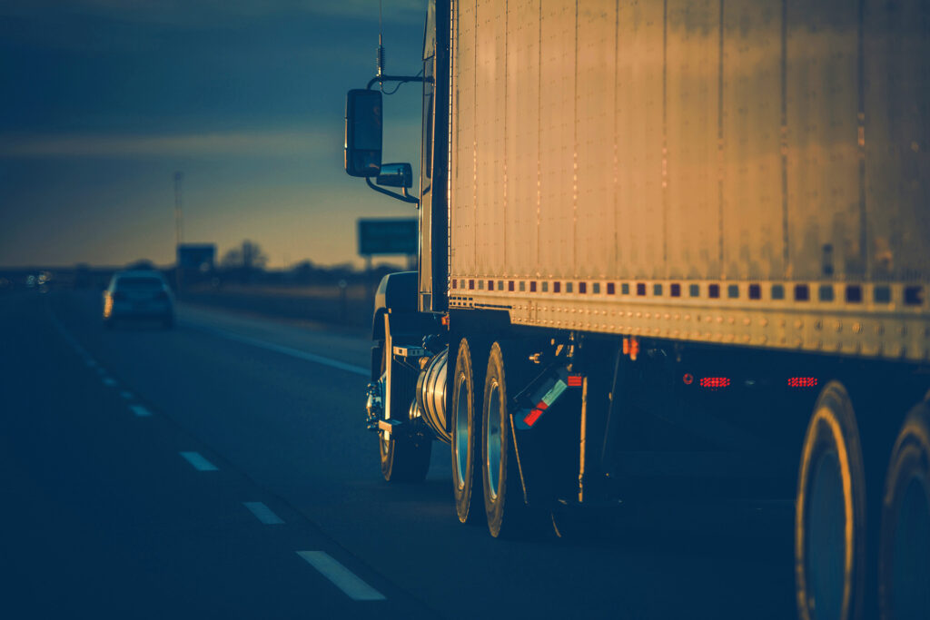 emi-truck driving down a highway at dusk, representing long-standing physiological questions such as is blood blue.